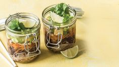 two mason jars filled with different types of food