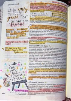 an open bible with colorful writing on it