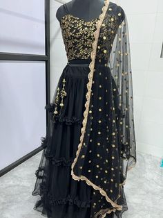 Designer black net ruffle indian wedding bridesmaid readymade lehenga choli for women or girls. Lehenga fabric: Net Blouse fabric : Raw silk Dupatta : net dupatta with sequin work Work : sequin-pearl work, ruffle style lehenga Blouse : Unstitch Lehenga : Semi Stitch Lehenga waist : Fits up to 42 waist  Bust size: Fits up to 44 waist  In plus size : fit up to 50. 👉 The flair of the lehenga will usually be 3.5 meter for free size but it will change according to your waist fitting. Our products ar Festive Black Organza Set, Black Organza Sharara For Festivals, Designer Ruffled Lehenga For Navratri, Designer Ruffled Lehenga For Festivals, Designer Lehenga With Ruffles For Navratri, Traditional Black Organza Sharara, Black Sharara With Dupatta For Party, Black Organza Sets With Zari Work, Party Black Anarkali Set With Sheer Dupatta