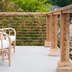 two chairs and a table on a balcony