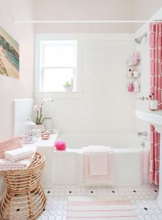 the bathroom is decorated in pink and white