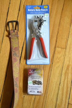 a pair of pliers sitting on top of a wooden floor next to a package