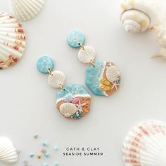 a pair of seashells and sea shells on a white background with the caption catch & clay seasideside summer