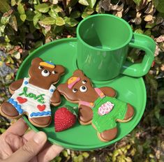 two decorated teddy bears on a green plate