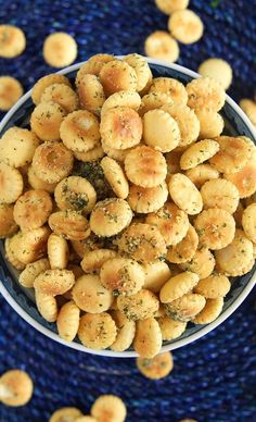 a bowl filled with crackers on top of a blue place mat