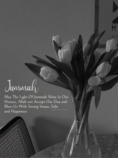 a vase filled with white flowers on top of a table