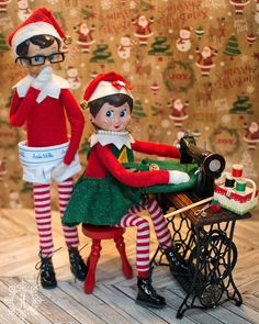 two elfs sitting on top of a toy bike