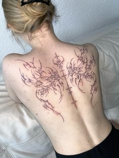 the back of a woman with tattoos on her chest