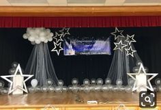 the stage is set up with balloons and stars for an award ceremony or graduation party