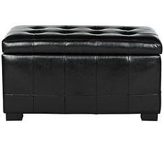 a black leather ottoman sitting on top of a white floor