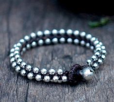 This bracelet made with 4mm silver plated beads woven together with dark brown waxed cord and silver bell for closure. *Size: Choose your size or color of cord from the drop-down menu. *✈️ Shipping.. The item shipped by registered airmail Thailand Post within 3-5 working days after payment received. - United States and Europe: It will take about 2-4 weeks to delivery after shipping. -Asia : It will take about 1-2 weeks to delivery after shipping. -Canada, Mexcigo South America : It will take abo Bohemian Silver Bracelet With Waxed Cord, Silver Braided Bracelet With Sliding Knot And Round Beads, Adjustable Silver Leather Bracelet With Round Beads, Silver Braided Bracelet With Sliding Knot, Silver Hand Wrapped Braided Bracelet For Friendship, Silver Beaded Wrap Bracelet For Friendship, Silver Leather Bracelet With Round Beads As Gift, Handmade Silver Leather Friendship Bracelet, Square Knot Bracelets