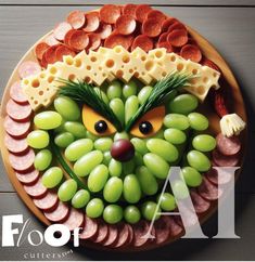 a plate that has grapes, cheese and meats on it with an animal face