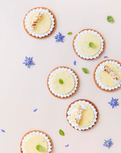 several cookies with different toppings are arranged on a table