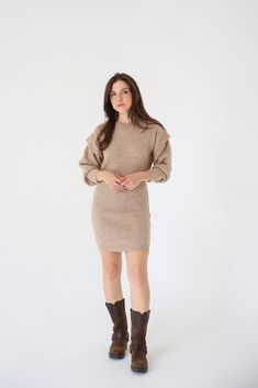 A ribbed knit mini dress with the following features: Round neckline. Bishop sleeves with ruffle detailing. Loose fit. Model Info: Height: 5 ft 8 in wearing Size S. Fall Bodycon Knit Mini Dress, Knit Mini Dress For Fall, Fall Ribbed Mini Dress, Fall Ruffled Mini Dress, Ribbed Knit Mini Dress, Chic Ribbed Knee-length Mini Dress, Chic Knee-length Ribbed Mini Dress, Fall Mini Dress With Ruffle Sleeves, Fall Ribbed Mini Bodycon Dress