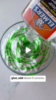 someone is pouring green liquid on top of some candy canes in a glass bowl