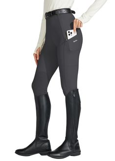 a woman in black riding pants and boots