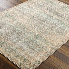 a large area rug on top of a wooden floor with wood floors in the background