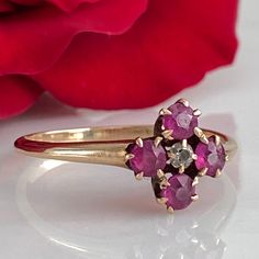 Details: Super sweet Victorian ring with diamond and pink/red rubies. The setting reminds me of flower. The ring is 14K rose gold, and has been tested. There are no markings on the interior of the band. There are four 3.25mm rubies and one 2mm diamond. Please ask all necessary questions prior to placing an order. Measurements: The size is 7 1/4 US and can be sized for a fee. Condition: The overall all condition of this ring is very good. Pink Cluster Ring With Rose Cut Diamonds For Anniversary, Pink Ruby Ring With Single Cut Diamonds, Heirloom Style Pink Cluster Ring For Anniversary, Antique Pink Diamond Rings, Antique Pink Ruby Ring With Rose Cut Diamonds, Victorian Pink Ruby Ring For Anniversary, Pink Ruby Ring In 14k Gold For Anniversary, Pink Victorian Ruby Ring For Anniversary, Pink Gold Ruby Ring With Diamonds For Anniversary