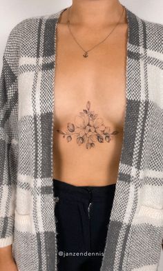 a woman with a flower tattoo on her chest