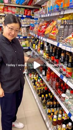 a woman standing in front of a store shelf filled with drinks and condiments