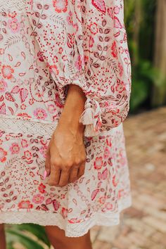 - Embrace the boho spirit with this dreamy dress! - Lined material with an abstract floral print featuring reds and pinks - An elastic scoop neckline - Loose ¾ length sleeves with drawstring closure cuffs featuring tassel accents - Crochet detail - Hidden side pockets - A flowy silhouette that ends in a mini dress length hemline Abstract Floral Print, Dreamy Dress, Crochet Details, Floral Mini Dress, Abstract Floral, Scoop Neckline, Dress Length, Length Sleeve, Floral Print