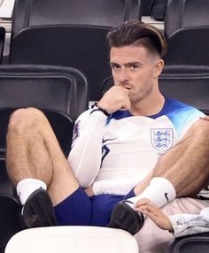 a man sitting in the stands with his legs crossed