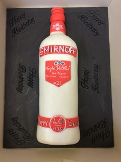 a cake made to look like a bottle of smirnoff with writing on it