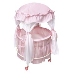 a pink baby crib with a canopy over it