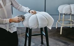 a person standing next to a stool with a doughnut on it's back