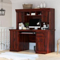 a wooden desk with a computer on top of it