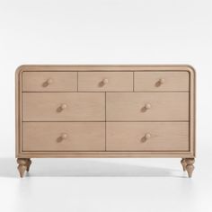 the chest of drawers is made from wood and has six drawers, one with two handles