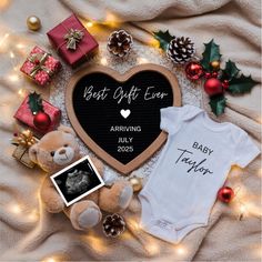 a baby's first christmas gift set on a blanket with presents and teddy bear