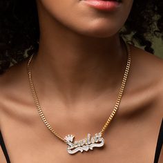 Our popular Double Plated Iced Princess Crown Name Necklace boasts a chic and elegant design, handcrafted to perfection. The model showcases the necklace with an 18-inch Cuban chain (see video for reference). You can personalize this item with Letters, Numbers, and Roman Numerals and choose from chain lengths of 14", 16", 18", and 20". Each chain features a lobster clasp closure for secure wear.Chain width:Cuban Chain - 3.7 mmFigaro Chain - 3 mmRope Chain - 2.3 mm XO Chain - 5 mm Gold Plated White Gold Chain Necklace For Anniversary, White Gold Plated Chain Necklace For Anniversary, Luxury Figaro Chain Pendant Jewelry, 14k Gold Nameplate Necklace With Adjustable Chain, Classic Gold Diamond Name Necklace, Luxury Gold Custom Necklace With Adjustable Chain, Luxury Custom Gold Necklace With Adjustable Chain, 14k Gold Curb Chain Pendant Necklace, Anniversary Cuban Link Necklace With Adjustable Chain