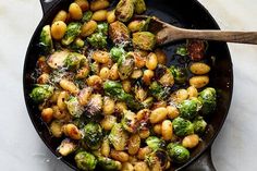 brussel sprouts and brussels sprouts in a skillet with a wooden spoon