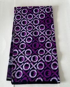 a purple and black cloth with circles on it