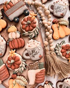 some cookies are laying on a table with decorations and other items around them that include pumpkins