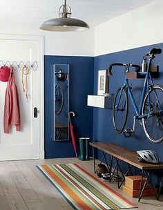 an image of a room with blue walls and bikes on the rack in front of it