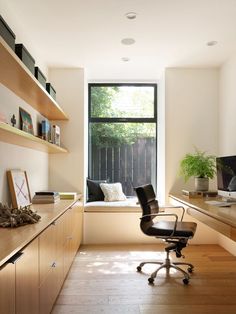 an office with a window, desk and chair