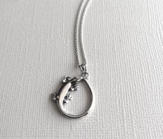 Beautifully hand crafted in 925 Sterling Silver, this charming Lizard Necklace is NICKEL-FREE and comes with a 16 inch Italian link chain. Material: 925 Sterling Silver Pendant Size: about 1 inch long Chain Length: 16 inch Rhodium Plated Italian Link Chain *Nickel-Free = Hypoallergenic *All purchases will arrive in a gift box! *Available in silver. Other chain lengths available upon request. *All orders are shipped via USPS First Class or Priority Mail. You will receive an e-mail with your track Gift Necklace With Spring Ring Clasp And Snake Chain, Sterling Silver Snake Chain Necklace Stamped 925, Sterling Silver Necklace With Stamped 925 Snake Chain, Elegant Stamped 925 Snake Chain Necklace, Sterling Silver Fine Jewelry Necklace With Lobster Clasp, Silver Necklace For Gift, Formal Sterling Silver Necklace, Oval Sterling Silver Necklace With Lobster Clasp, Lizard Necklace