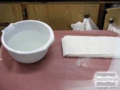 a white bowl sitting on top of a table next to a cloth