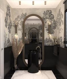 a bathroom with black and white wallpaper, gold fixtures and a large mirror over the sink