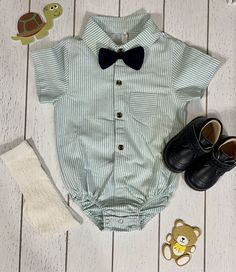 Boy navy shorts with suspenders, bowtie and striped light green shirt/romper shirt. 100% cotton. Size 12-18 months. Note: Shoes and socks not included, but available for purchase. Green Bow Tie For Summer, Shorts With Suspenders, Light Green Shirt, Shirt Romper, Shoes And Socks, Navy Shorts, Green Shirt, Outfit Set, Suspenders