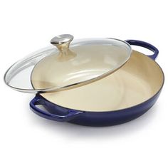 two blue and gold pans with lids on white background, one has a spoon in it