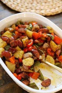 a white bowl filled with cooked vegetables on top of a wooden table next to a wicker basket