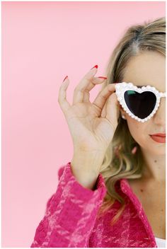 a woman wearing heart shaped sunglasses on her face