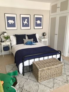 a bed room with a neatly made bed and two pictures on the wall above it