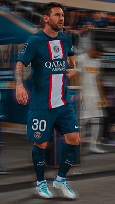 a man with tattoos on his arm is playing soccer