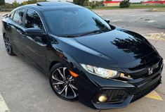 a black car parked in a parking lot