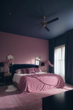 a bedroom with pink walls and black furniture