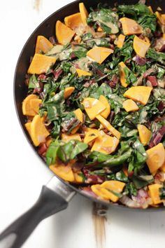 a pan filled with spinach and other vegetables